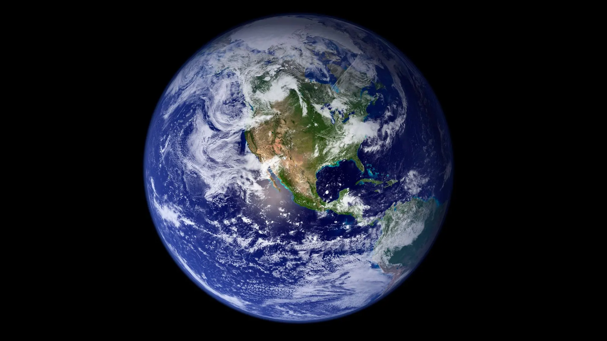 View of Earth from space showing North and Central America, with visible cloud formations over land and ocean against the blackness of space.